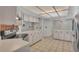 Spacious kitchen with white cabinetry, stainless steel appliances, and ample counter space at 7741 Merrily Way, Lakeland, FL 33809
