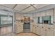Kitchen with white cabinets, stainless steel oven and decorative backsplash at 7741 Merrily Way, Lakeland, FL 33809
