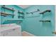 Laundry room featuring a washing machine and rustic shelving at 7741 Merrily Way, Lakeland, FL 33809