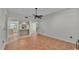 Bright living area with tile floors, ceiling fan, and adjacent kitchen view at 7741 Merrily Way, Lakeland, FL 33809
