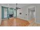 Open-concept living area with fireplace, ceiling fan, and tile flooring at 7741 Merrily Way, Lakeland, FL 33809