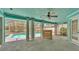 Enclosed patio with a ceiling fan featuring views of the swimming pool at 7741 Merrily Way, Lakeland, FL 33809