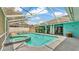 Outdoor pool with attached spa and screened enclosure for relaxing and enjoying at 7741 Merrily Way, Lakeland, FL 33809