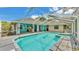 Enjoy the outdoors on the screened patio with a pool and spa for relaxation at 7741 Merrily Way, Lakeland, FL 33809