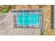 Aerial view of the screened-in pool with turquoise-colored water and a built-in spa at 7741 Merrily Way, Lakeland, FL 33809