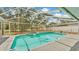 Inviting screened-in pool with attached spa and lush backyard views at 7741 Merrily Way, Lakeland, FL 33809
