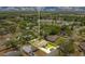 Aerial view of a property and neighborhood near a serene lake and lush greenery at 865 E Mann Rd, Bartow, FL 33830