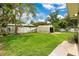 The expansive backyard featuring a shed, fence and a beautiful green lawn at 865 E Mann Rd, Bartow, FL 33830