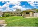 The exterior of the home with an expansive, grassy backyard at 865 E Mann Rd, Bartow, FL 33830