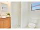 This bathroom features a stand up shower, vanity and toilet in a brightly lit room at 865 E Mann Rd, Bartow, FL 33830
