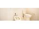 Bathroom featuring a toilet and bidet surrounded by neutral wall tiles at 865 E Mann Rd, Bartow, FL 33830
