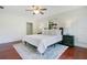 Cozy bedroom featuring wood floors, a ceiling fan, and neutral decor at 865 E Mann Rd, Bartow, FL 33830