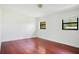 Empty bedroom with wood floors and bright light from two windows at 865 E Mann Rd, Bartow, FL 33830