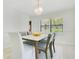 Elegant dining room featuring a marble-top table, stylish chairs, and a crystal chandelier for refined dining at 865 E Mann Rd, Bartow, FL 33830