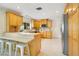 Bright kitchen with breakfast bar, stainless steel appliances, tile backsplash, and ample cabinet space at 865 E Mann Rd, Bartow, FL 33830