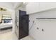 A laundry room with plenty of storage and a view into the bedroom at 865 E Mann Rd, Bartow, FL 33830