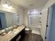 Well-lit bathroom featuring a tub and shower combination, modern vanity, and neutral color scheme at 879 Grandin St, Davenport, FL 33837