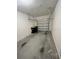 Spacious garage featuring a concrete floor, functional lighting, and a partially open garage door at 879 Grandin St, Davenport, FL 33837