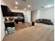 Open concept living area showcases a modern kitchen with stainless steel appliances and dark cabinetry at 879 Grandin St, Davenport, FL 33837