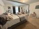 Spacious main bedroom featuring a four poster bed, neutral decor, and abundant natural light at 879 Grandin St, Davenport, FL 33837