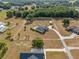 Aerial view of a home with a pool, spacious yard, and outbuilding on a large lot at 8909 N Campbell Rd, Lakeland, FL 33810