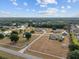 Sprawling aerial view of the community showcases a mix of homes surrounded by lush greenery at 8909 N Campbell Rd, Lakeland, FL 33810