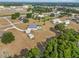 An aerial view of a property with a pool and shed, set on a large lot with scattered trees at 8909 N Campbell Rd, Lakeland, FL 33810