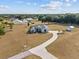 Expansive property featuring a well-maintained home with a long driveway and lush green surroundings at 8909 N Campbell Rd, Lakeland, FL 33810