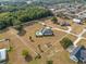 Aerial view shows a home on a large lot with a pool, outbuilding, and manicured landscaping at 8909 N Campbell Rd, Lakeland, FL 33810
