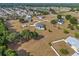 An aerial view of a home with a swimming pool, backyard shed, and surrounded by green trees at 8909 N Campbell Rd, Lakeland, FL 33810