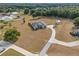 An aerial shot of a home on a large lot with a shed, long driveway, and manicured landscaping at 8909 N Campbell Rd, Lakeland, FL 33810