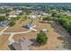 Aerial view of a single-Gathering home with a long driveway, expansive lawn, and mature trees at 8909 N Campbell Rd, Lakeland, FL 33810