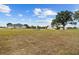 Expansive backyard featuring ample space for recreation, a firepit, and a glimpse of the home's exterior at 8909 N Campbell Rd, Lakeland, FL 33810