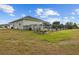 View of the backyard with black metal fence, propane tank, and a vegetable garden at 8909 N Campbell Rd, Lakeland, FL 33810