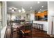 Open concept dining area with dark wood floors and a view into the living room and a breakfast bar at 8909 N Campbell Rd, Lakeland, FL 33810