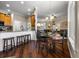 Dining area with hardwood floors and plenty of sunlight that connects with the kitchen and living room at 8909 N Campbell Rd, Lakeland, FL 33810