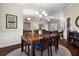 Charming dining area with a chandelier, open to the living room, and a lovely area rug at 8909 N Campbell Rd, Lakeland, FL 33810