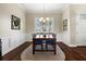 Traditional dining room featuring hardwood floors, and a dark wood table set with blue chairs and shuttered window at 8909 N Campbell Rd, Lakeland, FL 33810