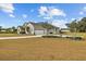 Spacious home featuring a three-car garage, well-kept landscaping, and a large yard at 8909 N Campbell Rd, Lakeland, FL 33810
