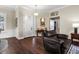 Inviting foyer with dark wood floors, decorative wainscoting, and a charming chandelier create a warm welcome at 8909 N Campbell Rd, Lakeland, FL 33810