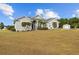 Charming home with large yard and well-manicured landscaping, with additional storage shed in back at 8909 N Campbell Rd, Lakeland, FL 33810