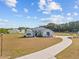 Charming single-story home features a well-manicured lawn and a long, curved driveway at 8909 N Campbell Rd, Lakeland, FL 33810