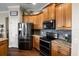 Updated kitchen with stainless steel appliances, granite countertops, and ample cabinet space at 8909 N Campbell Rd, Lakeland, FL 33810