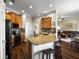 Well-designed kitchen with granite countertops, oak cabinetry, and a view into the living spaces at 8909 N Campbell Rd, Lakeland, FL 33810