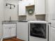 Well-equipped laundry room with washer, dryer, and granite countertop folding area at 8909 N Campbell Rd, Lakeland, FL 33810