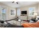 Cozy living room featuring dark wood floors, neutral walls, and a modern entertainment center at 8909 N Campbell Rd, Lakeland, FL 33810