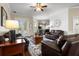 Comfortable living room with a ceiling fan, hardwood floors, and access to the backyard at 8909 N Campbell Rd, Lakeland, FL 33810
