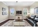 Relaxing living room with large windows, plantation shutters, wood floors, and comfortable furnishings at 8909 N Campbell Rd, Lakeland, FL 33810