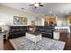 Cozy living room with hardwood floors, ceiling fan, modern entertainment center, and comfortable seating at 8909 N Campbell Rd, Lakeland, FL 33810
