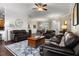 Spacious living room boasts a shiplap wall, hardwood floors, ceiling fan, and comfortable seating at 8909 N Campbell Rd, Lakeland, FL 33810